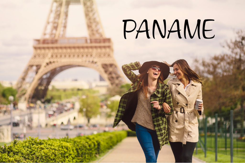 Two women laughing near the Eiffel Tower in Paris with the word Paname – modern expat life in Paname