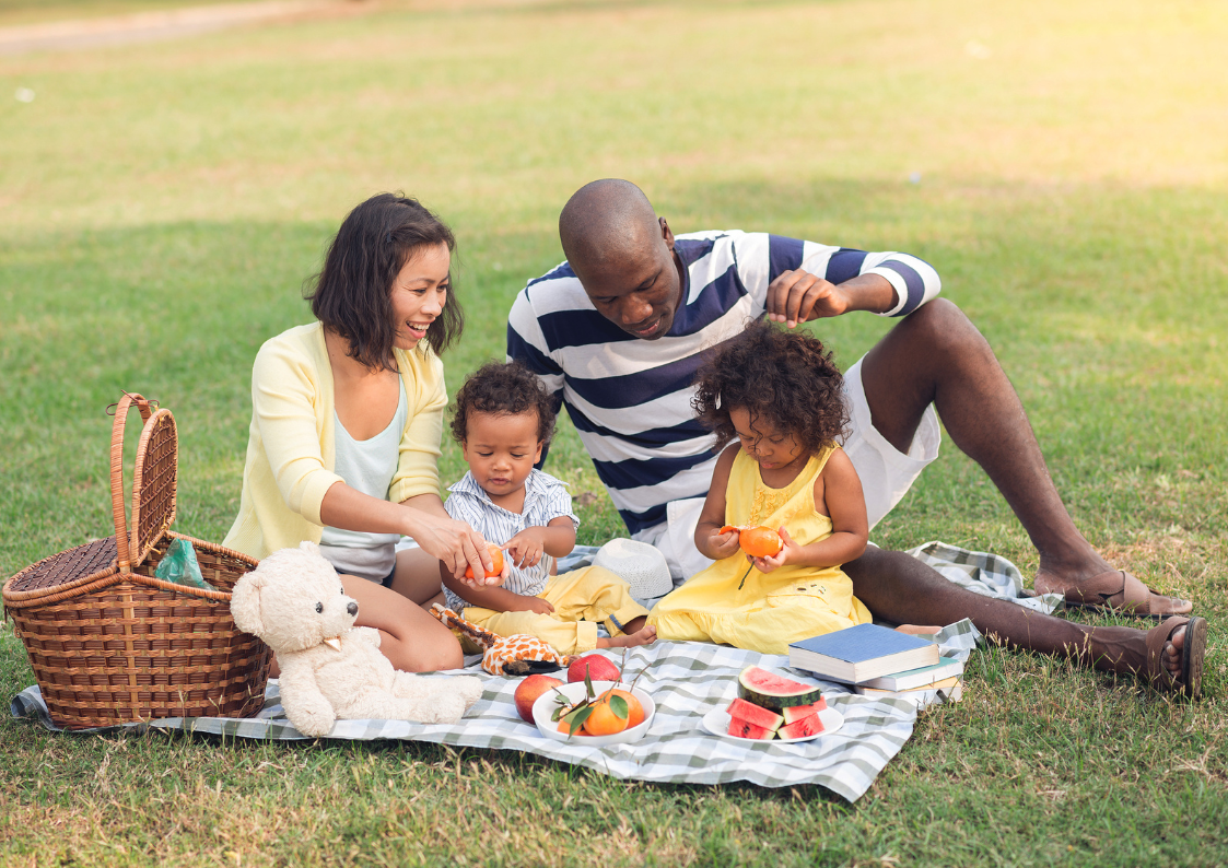 Expat family enjoying a picnic near a castle 